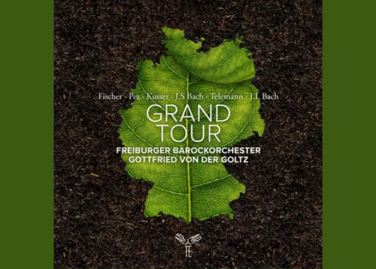 A green leaf on soil with text: Grand Tour, Freiburger Barockorchester, Gottfried von der Goltz, Fischer, Pez, Kusser, J.S. Bach, Telemann, J.L. Bach.