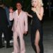 
Singer Bruno Mars was seen arriving at the Grammy after-party at the Birds Street Club in West Hollywood, California, alongside singer Rose. Bruno stood out in a pale pink suit, open-collar shirt, tinted sunglasses, and loafers, while Rose wore a strapless black gown with a thigh-high slit, ankle-strap heels, and styled short blonde curls.***El cantante Bruno Mars fue visto llegando a la fiesta posterior a los Grammy en el Birds Street Club de West Hollywood, California, acompañado de la cantante Rose. Bruno llamó la atención con un traje rosa pálido, camisa sin cuello, gafas de sol tintadas y mocasines, mientras que Rose deslumbró con un vestido negro sin tirantes con abertura alta, tacones con pulsera al tobillo y rizos rubios cortos.
