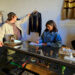 Seller Tristan hangs a jacket on the wall inside his vintage store