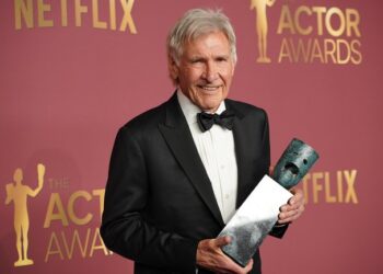 Harrison Ford poses in the press room with the lifetime achievement award.