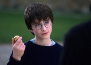 Harry holding up the Golden Snitch in Harry Potter and the Sorcerer's Stone