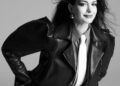 Fashion editorial featuring a model in a black leather jacket and white tie.