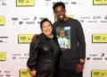 Youth Music's co-chairs Guvna B and Charlotte Edgeworth posing at the Youth Music Awards 2025