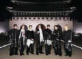 BTS stands in front of Gwanghwamun, the main gate of Gyeongbok Palace, during their comeback concert in Seoul’s Gwanghwamun Square on March 21, 2026. (courtesy BigHit Music, Netflix)