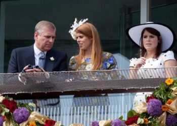 Andrew Mountbatten-Windsor, Princess Beatrice and Princess Eugenie attend the Derby Stakes at Epsom Racecourse in 2011. By: MEGA