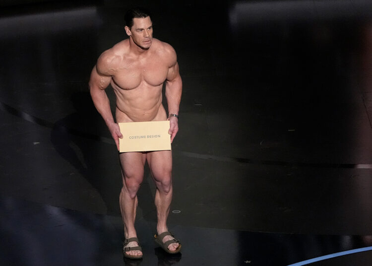 John Cena presents the award for best costume design during the Oscars on Sunday, March 10, 2024, at the Dolby Theatre in Los Angeles.