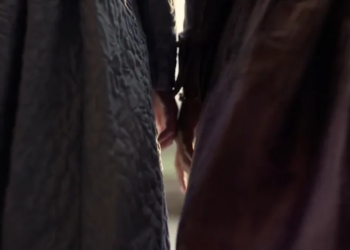 Francesca Bridgerton and Michaela Stirling's hands touch.