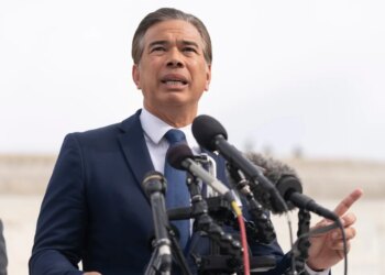 California Attorney General Rob Bonta speaking into several microphones.