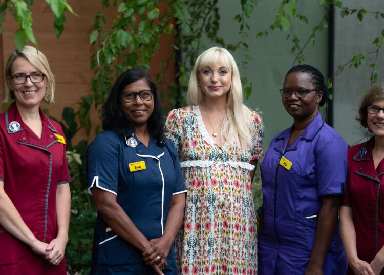 Helen George with a group of Nightingale nurses in the Florence Nightingale Garden, 2021
