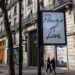 Pedestrians walk past a billboard displaying the title of Canadian singer Celine Dion's song
