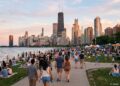 Crowds enjoying a summer festival in Chicago’s Grant Park at sunset with skyline and lake in view.