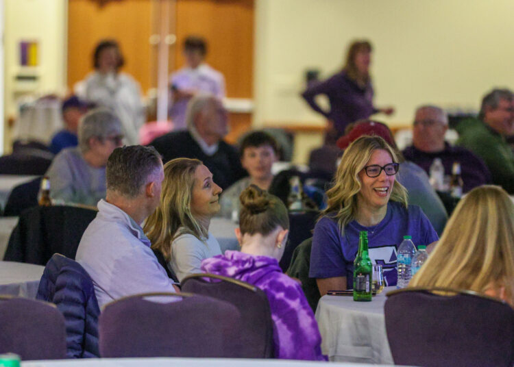 Attendees wait for the game to start during a watch...
