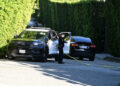 A police officer is seen outside Rihanna's Beverly Hills home after a report of gunshots on March 8, 2026Credit: DUTCH/Bauer-Griffin/GC