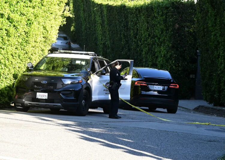 A police officer is seen outside Rihanna's Beverly Hills home after a report of gunshots on March 8, 2026Credit: DUTCH/Bauer-Griffin/GC