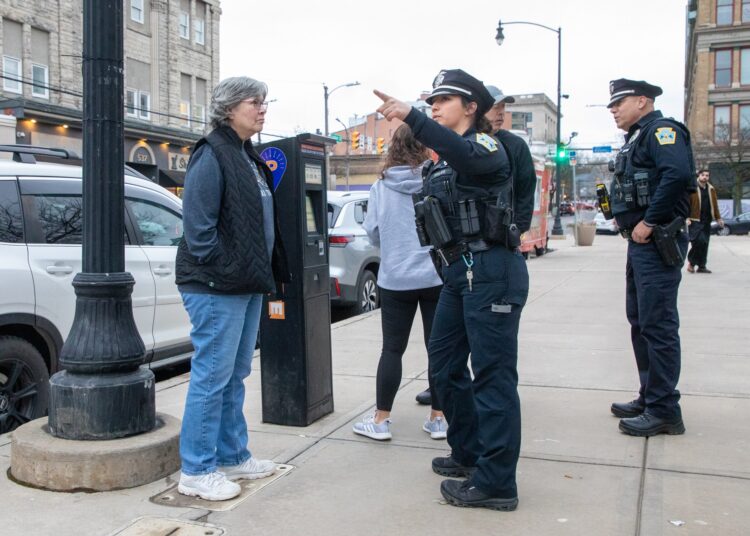 Patrol officer Olivia Muchal gives directions to Charlotte Disney in...