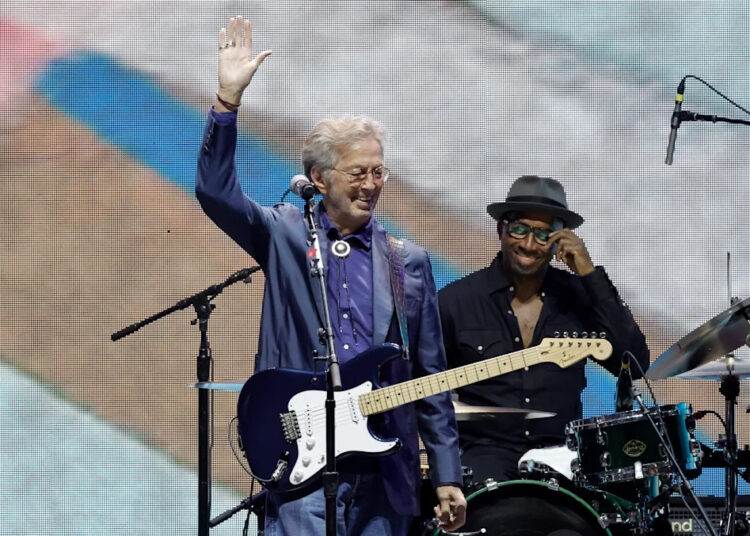 Eric Clapton waves to the fans during the Crossroads Guitar Festival at Crypto.com Arena on Sept. 24, 2023, in Los Angeles.