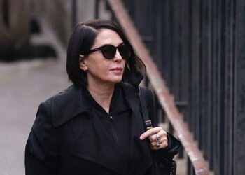 Sadie Frost wearing sunglasses and a black jacket before entering court