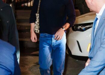 person walking in casual attire outside at night