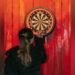 A woman with long dark blonde hair holds dart in front of a dartboard. The dartboard surround is orange and black and the dartboard is mounted on a wood panelling which is painted a rustic red. The woman is photographed from behind.