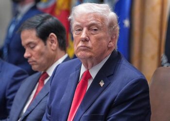 Trump listens in a meeting in January 2026