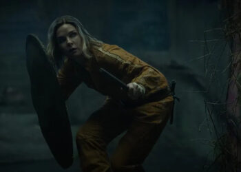 Juliette protecting herself with a shield as she crouches stealthily in Silo