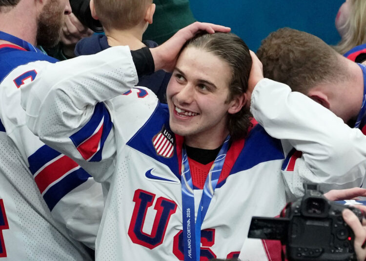 Jack Hughes of the United States celebrates after winning the men's ice hockey gold medal game during the Milano Cortina 2026 Olympic Winter Games at Milano Santagiulia Ice Hockey Arena.