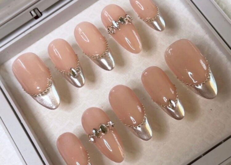 A set of cat eye French manicure nails