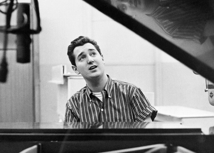 (Original Caption) 12/17/60: Singer Neil Sedaka seated at a piano.