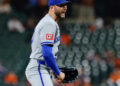Kansas City Royals manager Matt Quatraro reacts after Mitch Spence turns heads during Spring Training outing