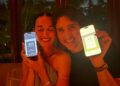 Two people holding their smartphones displaying health metrics.