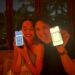 Two people holding their smartphones displaying health metrics.