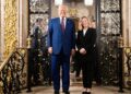 A man and a woman standing and smiling at the camera