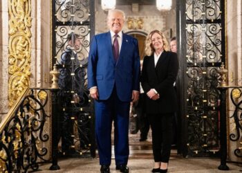 A man and a woman standing and smiling at the camera