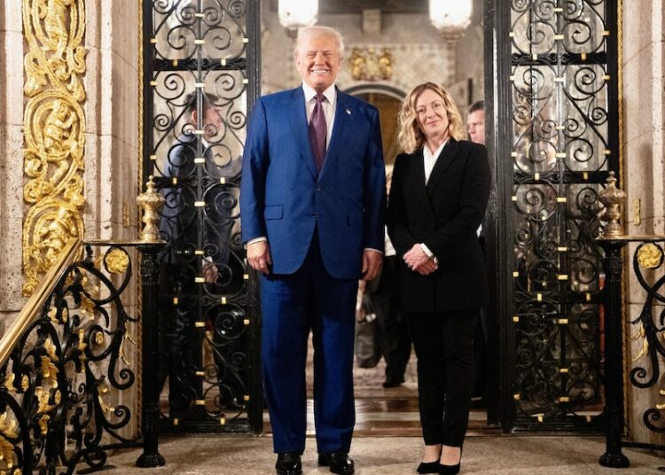 A man and a woman standing and smiling at the camera