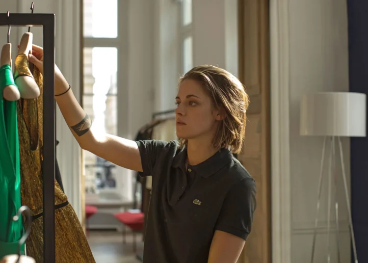 A young woman (Kristen Stewart) is shopping for clothes in the movie Personal Shopper.