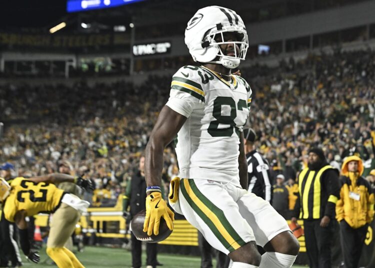 Green Bay Packers wide receiver Savion Williams (83) scores a touchdown against the Pittsburgh Steelers during the third quarter at Acrisure Stadium.