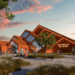 A digital rendering of a modern wooden venue with triangle roofing