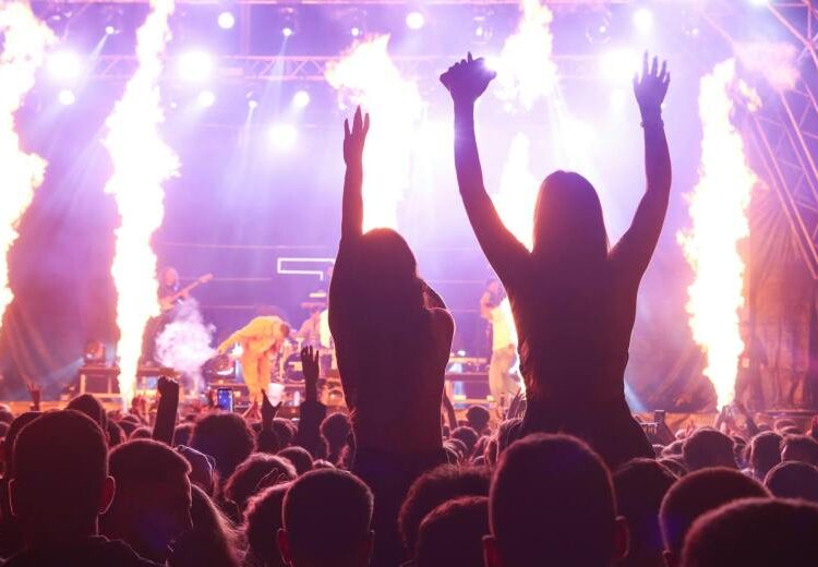 vibrant concert scene with crowd and fire effects