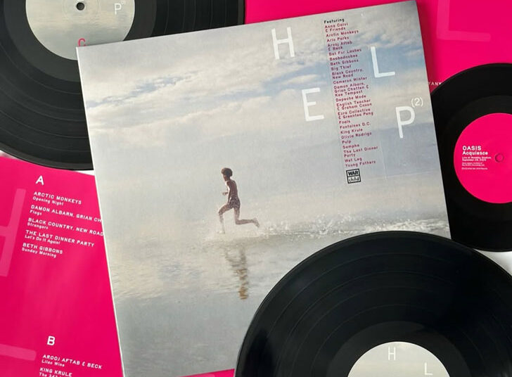 A flat-lay of a vinyl record of War Child Records "Help(2)"