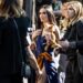 Demi Moore walks in a crowd of people while carrying her dog.