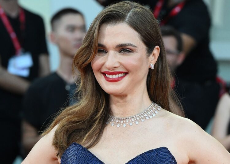 A woman smiles in a promotional setting