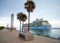 Man watching the Royal Caribbean International's Freedom of the Seas cruise ship depart from PortMiami.