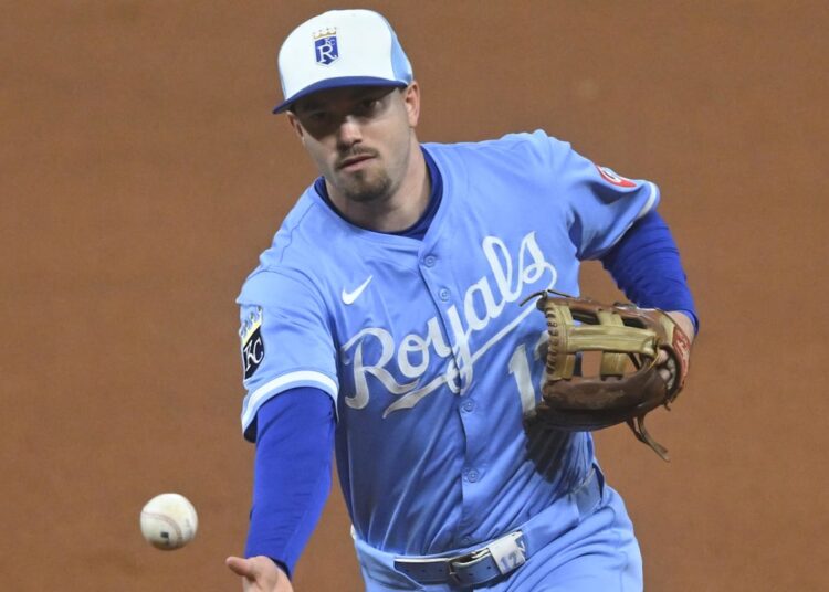 Sep 9, 2025; Cleveland, Ohio, USA; Kansas City Royals second baseman Nick Loftin (12) tosses the ball to first base in the seventh inning against the Cleveland Guardians at Progressive Field. Mandatory Credit: David Richard-Imagn Images