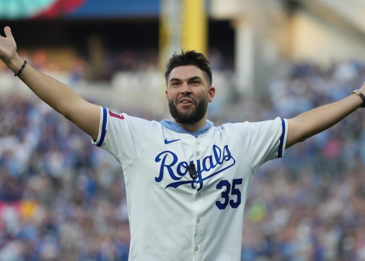 Oct 9, 2024; Kansas City, Missouri, USA; Form Kansas City Royals player Eric Hosmer throws out the cerominal first pitch before the game between the New York Yankees and the Kansas City Royals during game three of the NLDS for the 2024 MLB Playoffs at Kauffman Stadium. Mandatory Credit: Jay Biggerstaff-Imagn Images