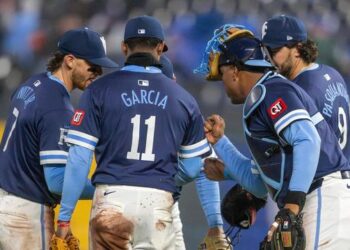 Kansas City Royals shortstop Bobby Witt Jr. (7), third baseman Maikel Garcia (11), first baseman Vinnie Pasquantino (9) and catcher Salvador Perez (13) celebrate an 8-2 victory over the Baltimore Orioles on Friday, April 4, 2025, at Kauffman Stadium.