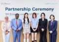 K-pop girl group Hearts2Hearts' members Jiwoo, center right, and Carmen, center left, pose with SM Entertainment and UNICEF officials  at the partnership ceremony at UNICEF Indonesia office in Jakarta, Friday. Courtesy of SM Entertainment