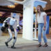 Kelly Ritz of Walnut Creek, California, reacts while dancing with a Unitree G1 humanoid robot at the SXSW Expo: International Innovations at the Fairmont Hotel during South by Southwest in Austin on Thursday, March 12, 2026. The expo brings together global companies and startups showcasing emerging technologies. (Jay Janner/Austin American-Statesman)