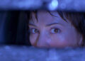 Michelle Mancini looking in the rearview mirror in Urban Legend