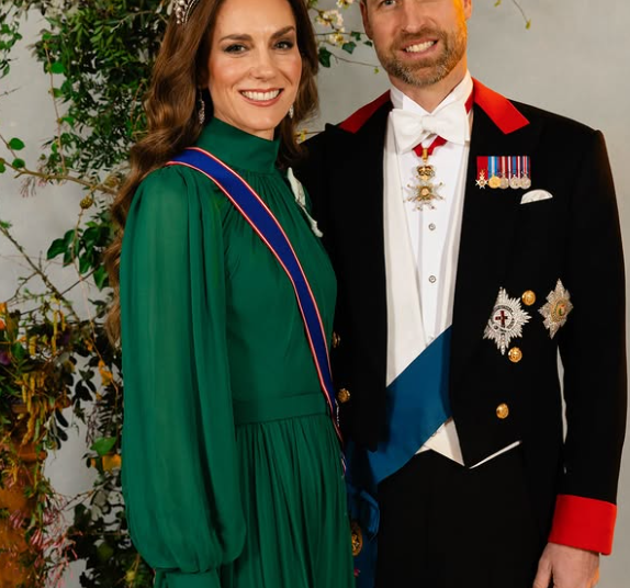 The Prince and Princess of Wales stand in front of a plant for a formal portrait