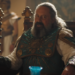 seated figure with ornate costume and accessories in a regal setting